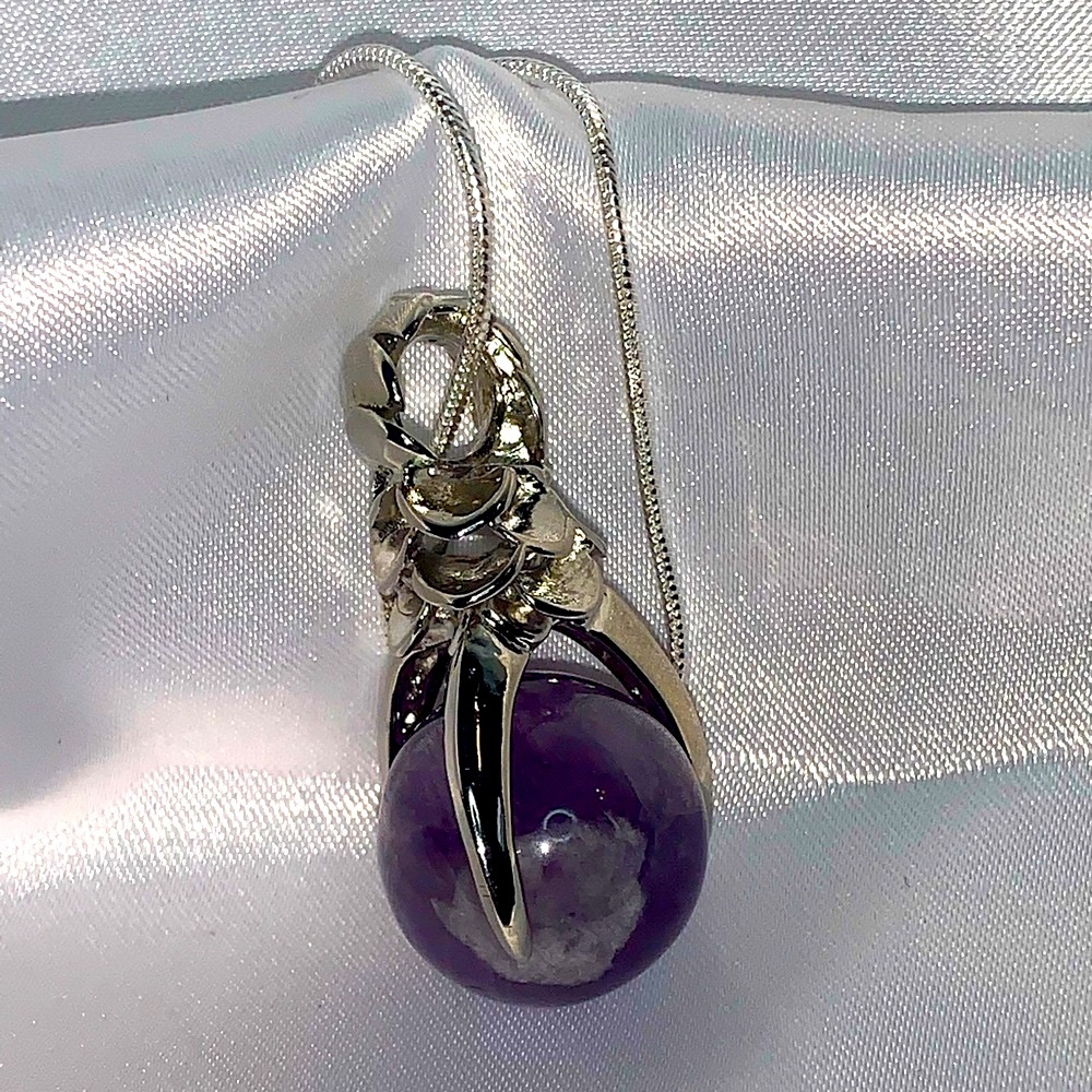 Amethyst ball with Silver dragon claw necklace.